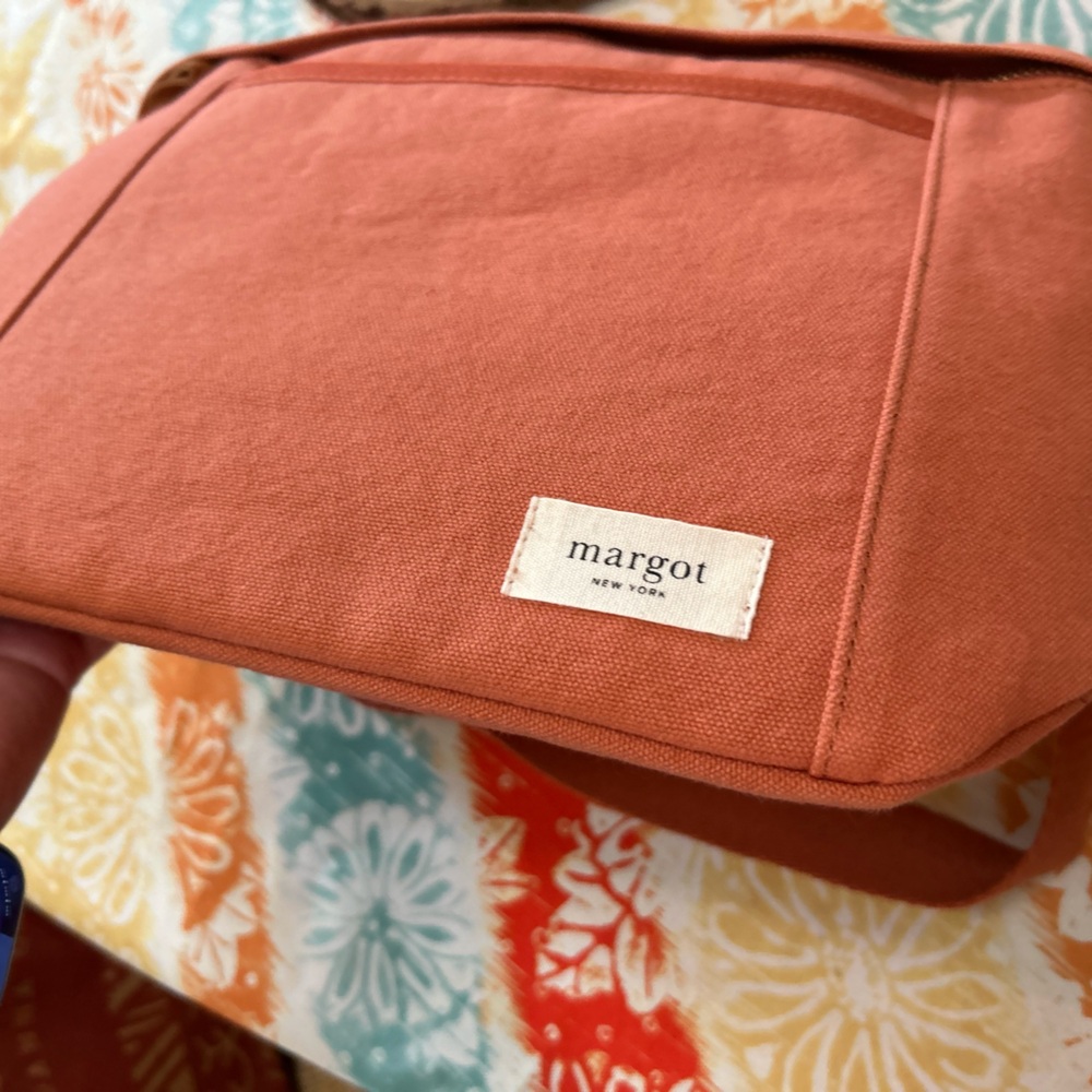 Margot “Lindsey Sling Bag” in a subtle orange color